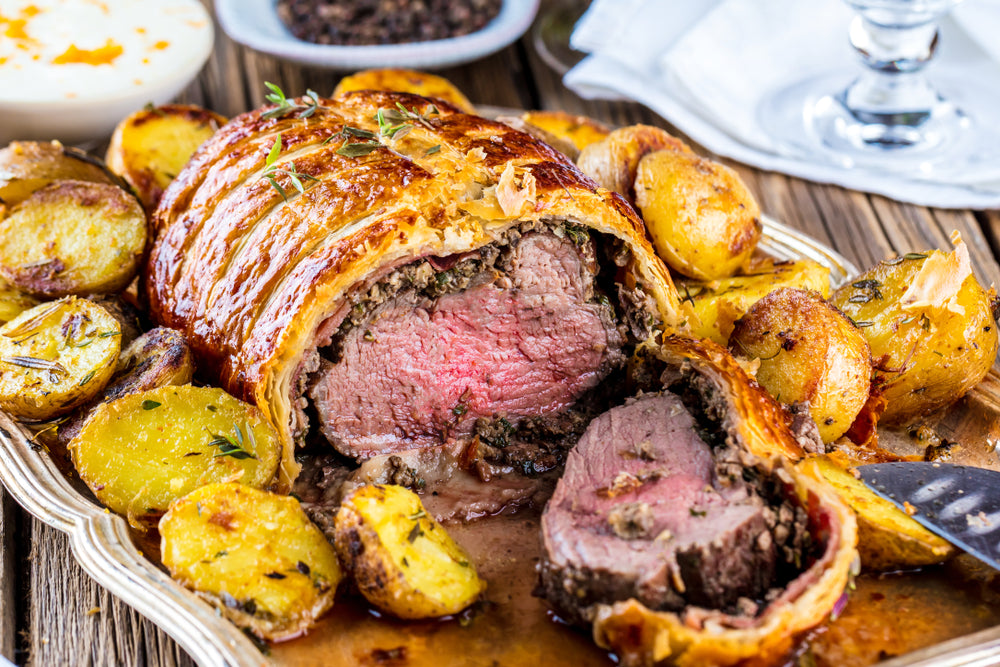 Beef Wellington, classic steak dish on rustic wooden table